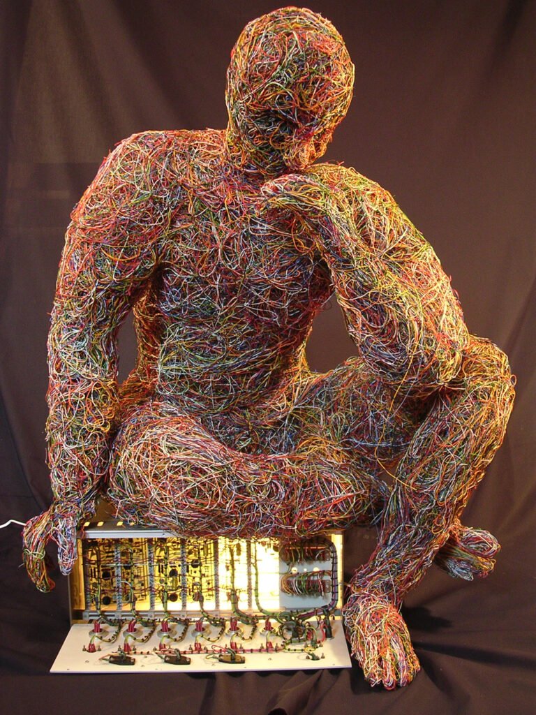 M.P.O.D.S Life-sized seated Wire Sculpture with inner light. Created by Sculptor Craig Clarke BA(Hons)